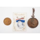 A George VI coronation commemorative medallion affixed to its original backing card, together with