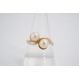 A twist-set pearl dress ring, the 5 mm twin pearls set on a 9 ct gold shank, O/P