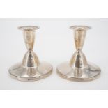 A pair of silver candle sticks, Reid & Sons, Birmingham, 1958, loaded, 8 cm