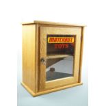 [ Die-cast toy cars ] A Matchbox Toys glazed oak display cabinet, 51 cm x 28 cm x 56 cm