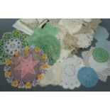 A quantity of vintage hand-crocheted and embroidered doilies or jar covers including one pink