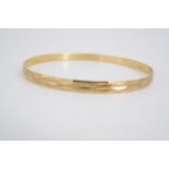 A high carat yellow metal bangle, stamped 750 and tested as 18 ct gold, 14.6 g
