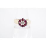 A ruby and diamond flowerhead cluster ring, the stones set of a broad tapering 9 ct gold shank, P