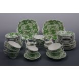 A Coalport tea set decorated in a pattern of green dragons, comprising 8 tea cups, 12 saucers, 11