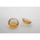 Two round-cut faceted citrine gemstones, unset, each approximately 8mm