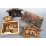 A quantity of Black Forest style wooden novelties including relief-carved plaques, chalets and