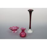 A controlled bubble glass bud vase, 29 cm high, a cranberry bowl and small vase, 9 cm high