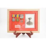 Framed British War and Victory medals together with a driving medal to 156889 Gnr H J Hawkins, RA