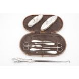 A cased silver-mounted part manicure set, two silver nail buffs and a button hook