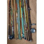 A quantity of vintage fishing rods including Greenheart, fibre glass etc.
