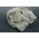 A large quantity of vintage whitework napkins contained within a vintage pillow case