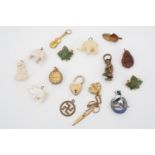 A collection of vintage charms, badges and miniatures, including a mother-of-pearl piglet, a