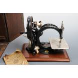 A cased Victorian Willcox and Gibbs hand-cranked sewing machine