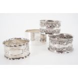 A pair of Edwardian silver napkin rings and two others