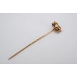 A Victorian pearl and yellow metal stick pin, the pearl set within an open reef knot of cabled and