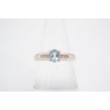 A blue topaz and diamond ring, the oval-cut central stone claw-set on 9 ct white gold, the shoulders