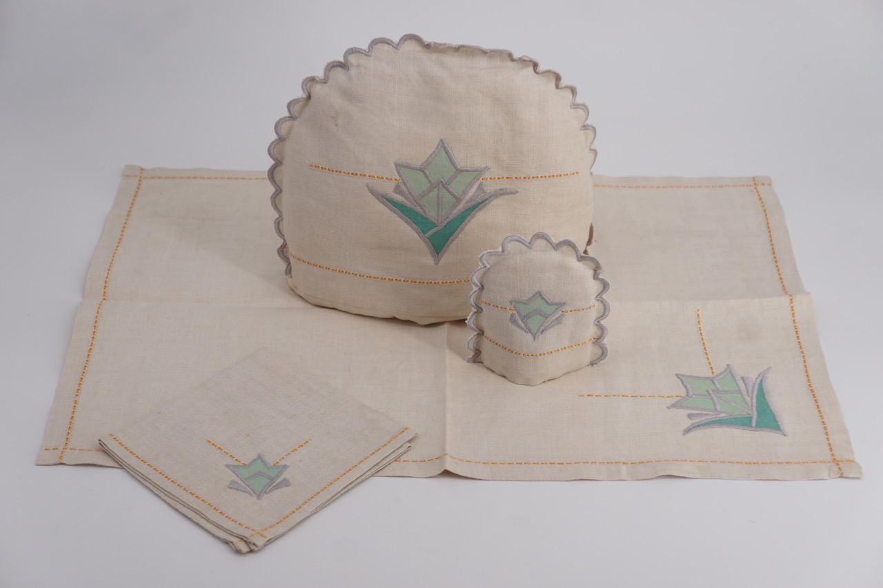 An Art Deco hand-embroidered breakfast / tea tray linen set, including tea pot cosy, egg cosy,