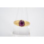 A pink topaz finger ring, the oval stone claw set on a tapering high carat yellow metal shank with