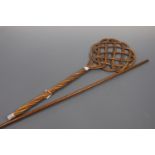 A 19th Century cane carpet beater together with a yard stick