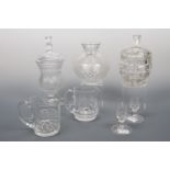 A crystal lidded jar, 30 cm high, a glass biscuit barrel, two Edinburgh crystal water jugs, 13 cm