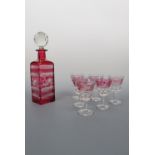 A ruby flashed and wheel cut decanter together with six conforming glasses