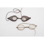 A set of Victorian dust goggles together with vintage spectacles