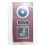 A Warner Brothers platinum CD disc sales award presented to Eric Clapton's manager Roger Forrester