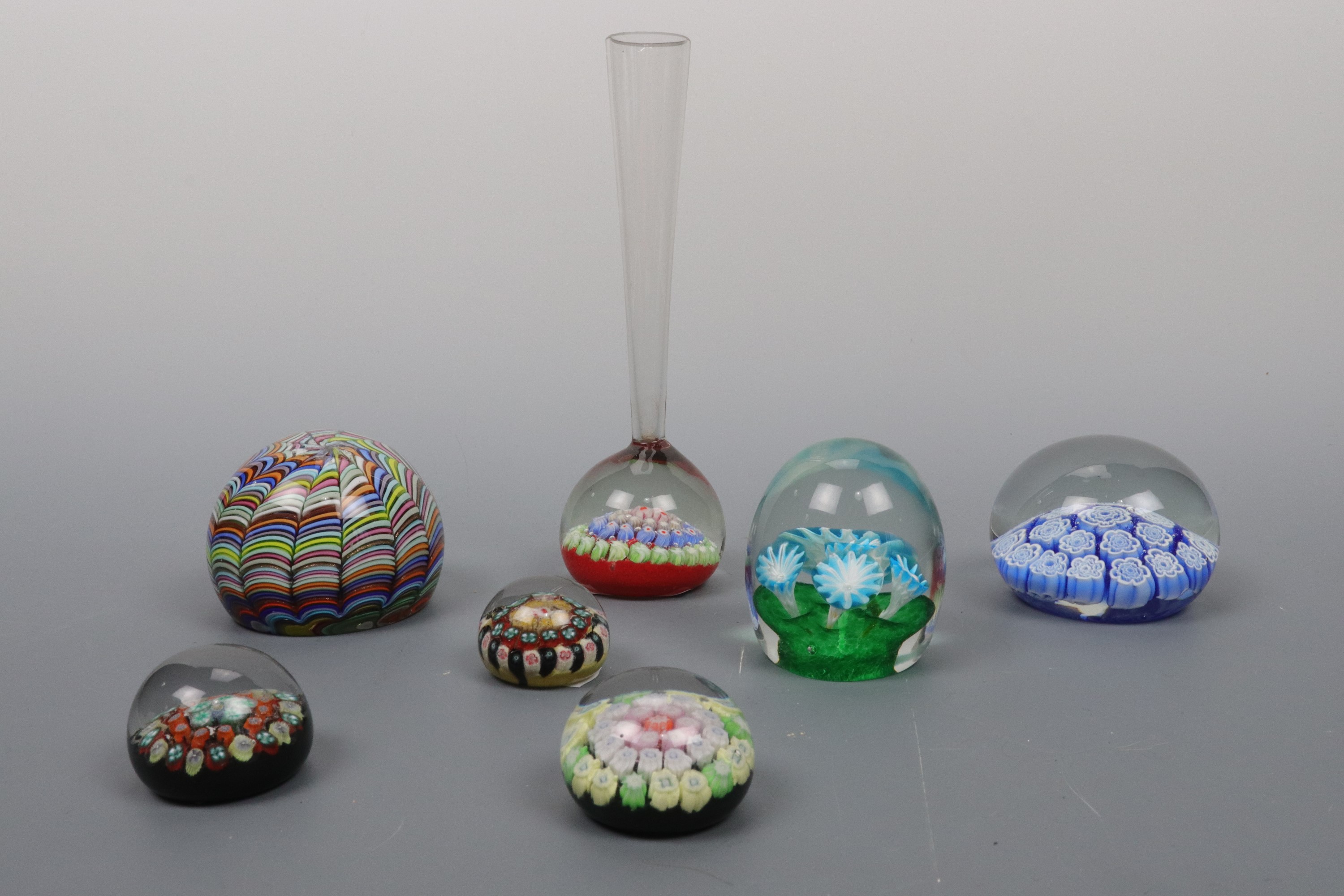 Two Murano glass paperweights and five others