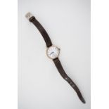 A 1950s lady's Record 9 ct gold wristlet watch, having a manual movement and circular white enamel