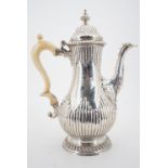 A George III silver baluster coffee pot with ivory handle, having gadrooned decoration, and engraved