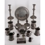 A large quantity of pewter including two pairs of candlesticks, a tray and five tankards, a teapot