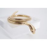 A late 20th Century 9 ct gold serpent-form flexible bracelet, having garnet eyes, (steel cored)