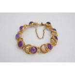 An amethyst and gilt white metal bracelet, comprising circular cabochons set on convex cannetille