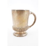 A Victorian silver Christening cup, of subtly tapering form with gadrooned base and moulded foot,