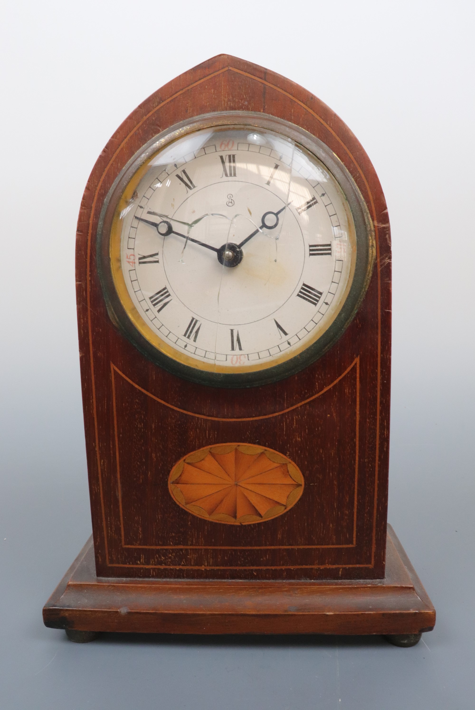 An Edwardian Sheraton Revival mantle clock of Gothic arch form, 23 cm