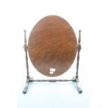 A mahogany oval toilet mirror, 56 cm high