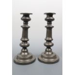 A pair of 19th Century pewter candlesticks, 21 cm
