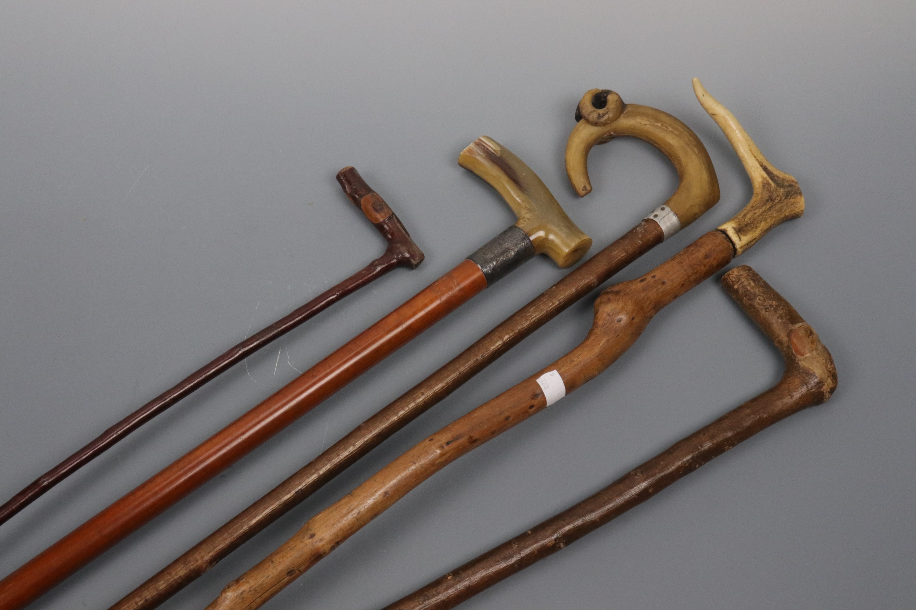 A horn handled walking cane and four others