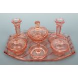 A 1930s pink pressed glass dressing table set