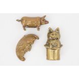 Four brass novelty and other vesta cases, respectively modelled as the man in the moon, a cat in a