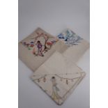 Three early 20th Century table cloths inspired by the Orient, one decorated with figures beneath