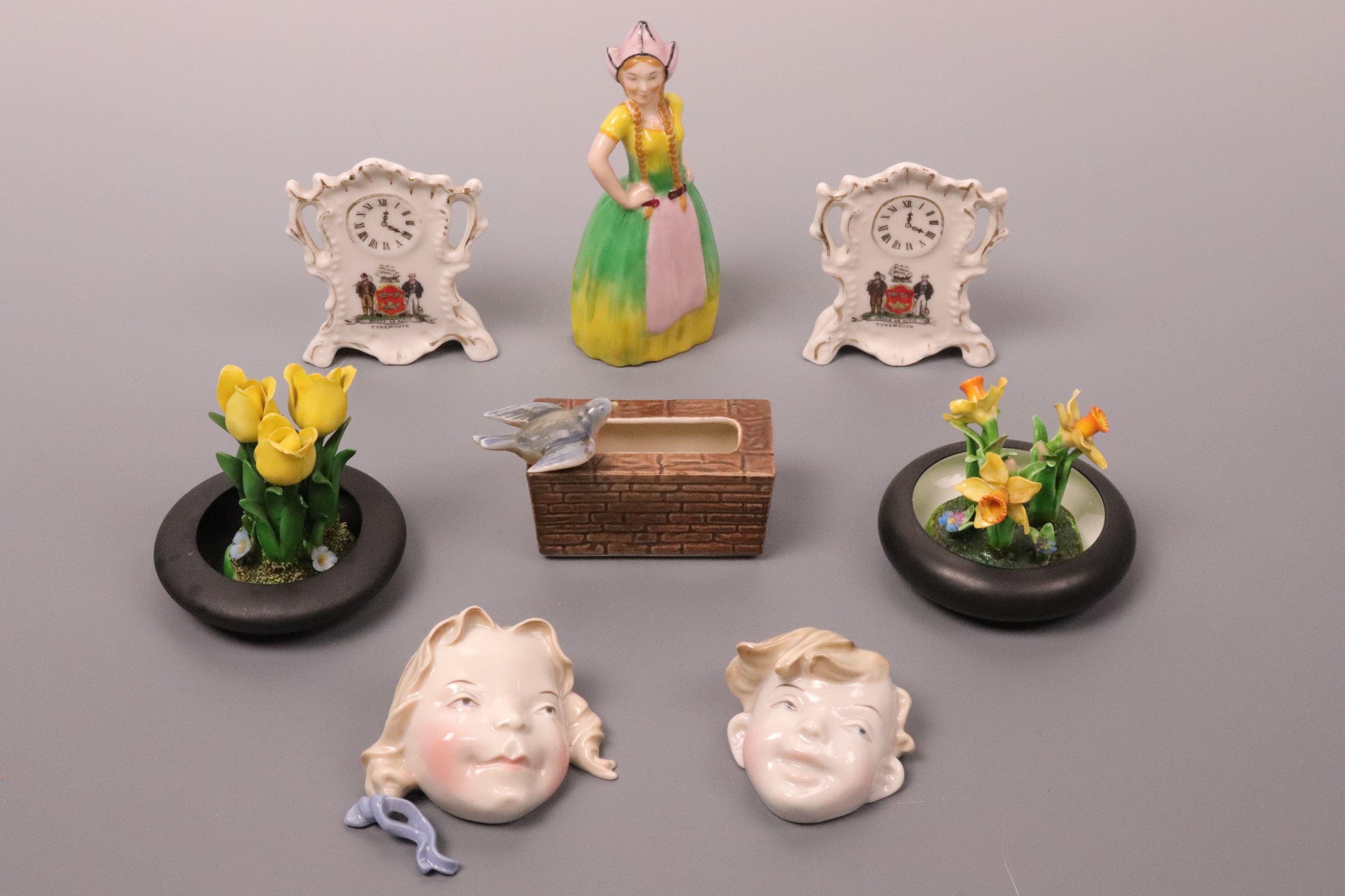 A group of novelty ceramics including Goss daffodils, an Arcadian China Miss Holland,