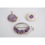 Three amethyst and white metal brooches / pendants