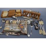 A quantity of flatware including boxed knives, a pair knife rests etc.
