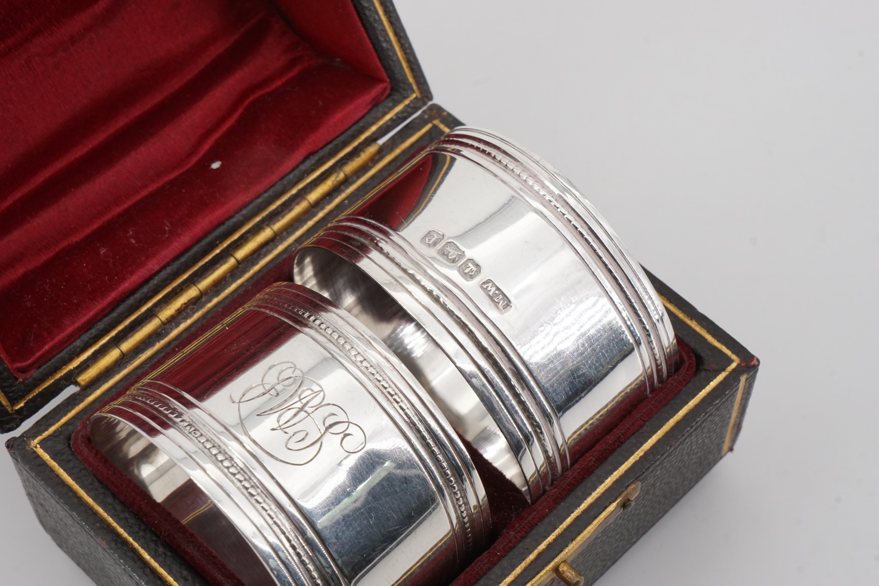 A cased pair of Victorian silver napkin rings, each of cylindrical form bearing reeded and beaded - Image 2 of 3