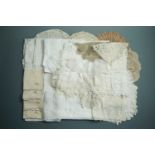 A quantity of antique and vintage whitework embroidery table linens and doilies of lace and crochet