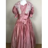 A lipstick-pink shot-silk theatrical costume Victorian dress, with sweetheart neckline, puffed
