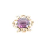 A Victorian yellow metal mounted amethyst brooch, the oval stone (18 x 15 mm) set within open C-