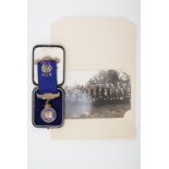A 1930s silver-gilt Masonic jewel with presentation case and period photograph of the lodge, 35.2g