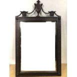 An early 20th Century Georgian-influenced mahogany-framed wall mirror, the rectangular plate in a